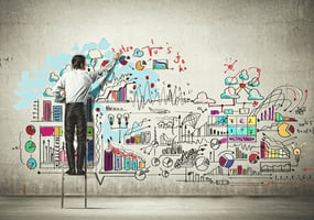 man placing diagram of business information on a wall